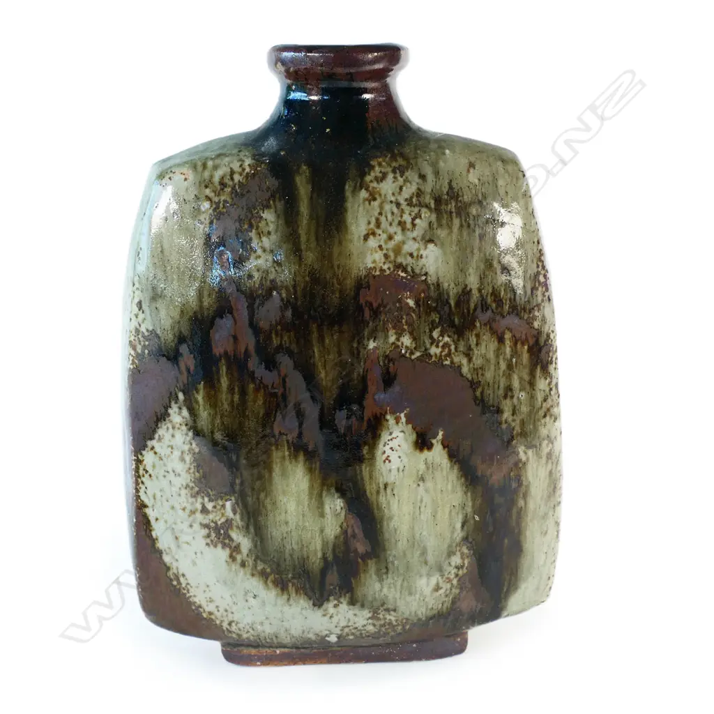 Doreen Blumhardt (1914-2009) stoneware slab vase with red and tenmoku poured glaze - tapered rectangular body with waisted circular rim and rectangular foot. Poured dark red/brown glaze with red highlights. Impressed potter's mark. c.1970. H.285mm. Image 1++