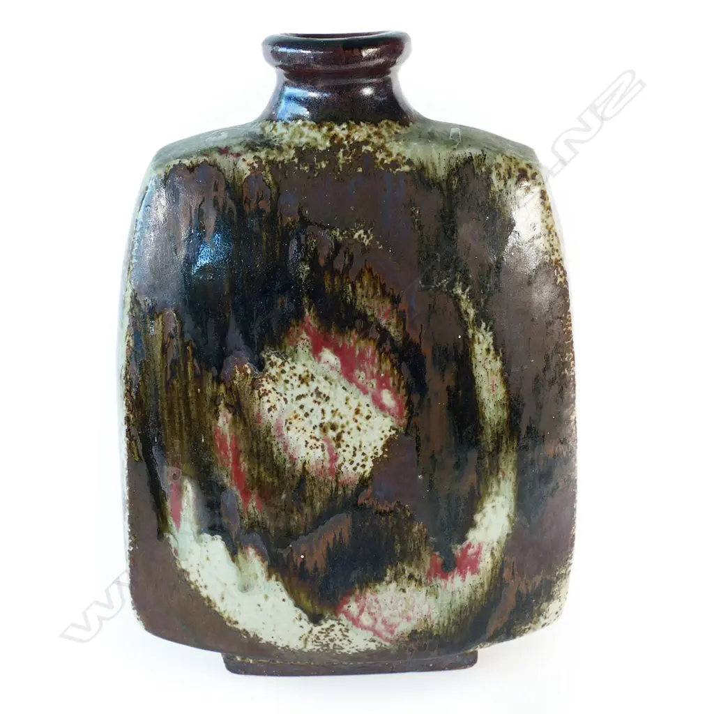 Doreen Blumhardt (1914-2009) stoneware slab vase with red and tenmoku poured glaze - tapered rectangular body with waisted circular rim and rectangular foot. Poured dark red/brown glaze with red highlights. Impressed potter's mark. c.1970. H.285mm. Image 1++