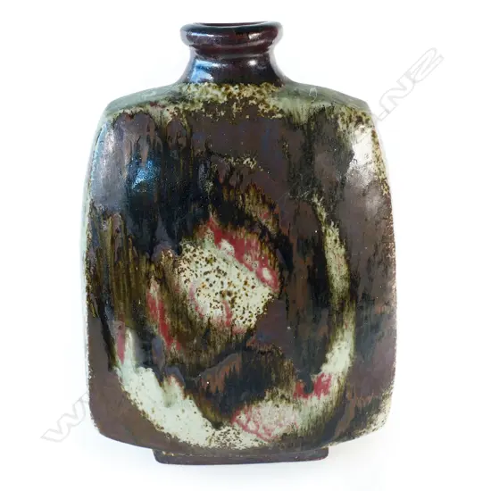 Doreen Blumhardt (1914-2009) stoneware slab vase with red and tenmoku poured glaze - tapered rectangular body with waisted circular rim and rectangular foot. Poured dark red/brown glaze with red highlights. Impressed potter's mark. c.1970. H.285mm.