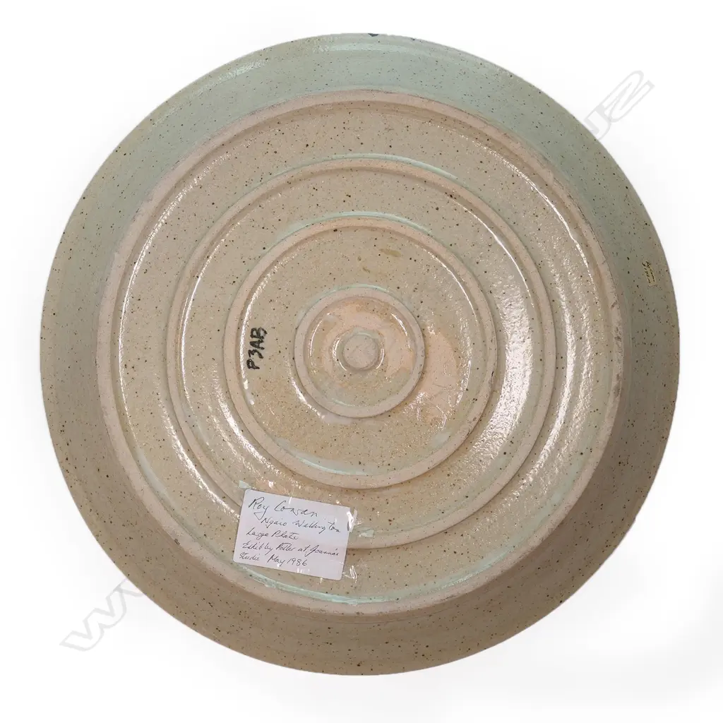 A large Roy Cowan pottery platter decorated with native flora and fauna designs together with iconic NZ subjects, various colours on a stone toned ground, etched initials to base. Dia.395mm. Image 1++