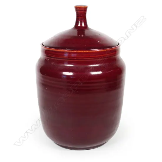 An Olive Jones (1893-1982) maroon glazed lidded pot. Signed and dated '42 to base. H.210mm.