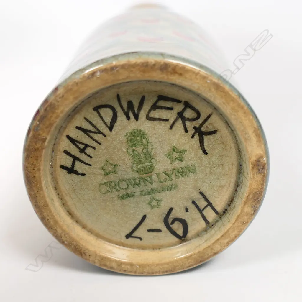 Frank Carpay for Crown Lynn figural oil bottle. The cylinder body decorated with restrained repeated fabric motif and stylised facial detail - pouring lip to rear. HANDWERK H.9-7 signature and Crown Lynn Tiki stamp to base. H.170mm. Image 1++