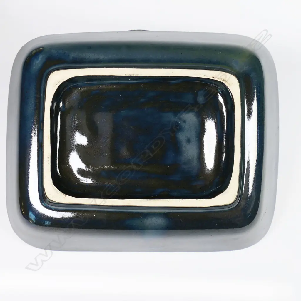 Crown Lynn Ngakura Ware dish - a rectangular dish in black-green glaze impressed with elaborate Māori designs. Unmarked on base. Designed by Crown Lynn for the tourist market and manufactured by Luke Adams in Christchurch. 120 x 150mm Image 1++