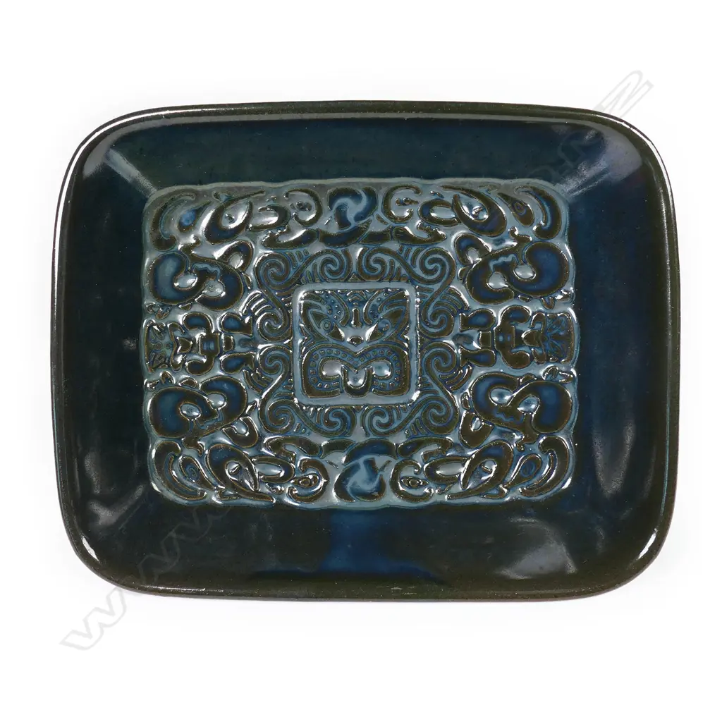 Crown Lynn Ngakura Ware dish - a rectangular dish in black-green glaze impressed with elaborate Māori designs. Unmarked on base. Designed by Crown Lynn for the tourist market and manufactured by Luke Adams in Christchurch. 120 x 150mm Image 1++