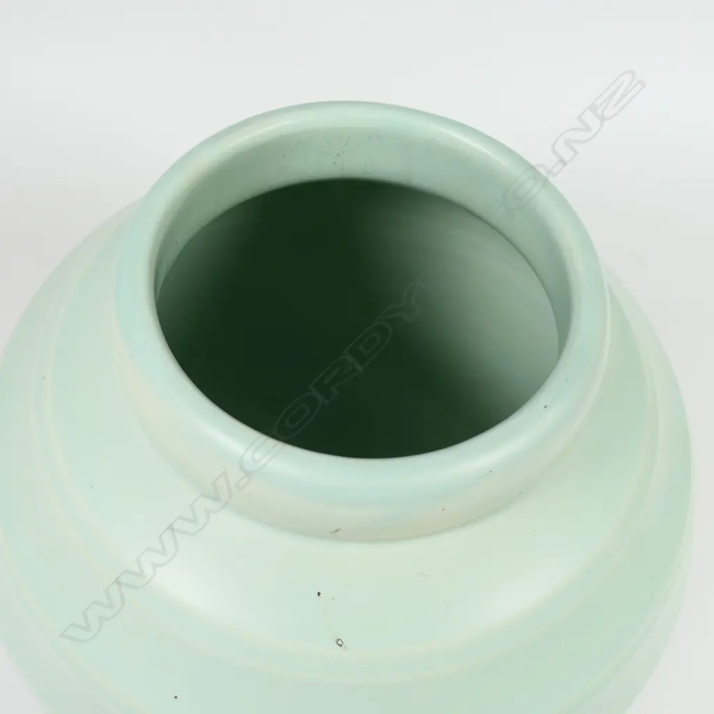 Crown Lynn Hand Potted pale teal green vase - medium size, shape 14 with six concave bands to the spherical body. Chip to foot. H.184mm. Image 1++