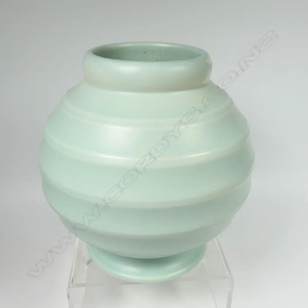 Crown Lynn Hand Potted pale teal green vase - medium size, shape 14 with six concave bands to the spherical body. Chip to foot. H.184mm. Image 1++