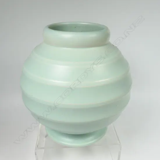 Crown Lynn Hand Potted pale teal green vase - medium size, shape 14 with six concave bands to the spherical body. Chip to foot. H.184mm.
