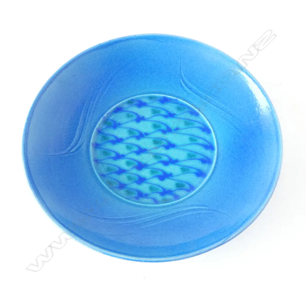 Merilyn Wiseman (1941-2019) round wide footed dish blue glazed with a central disc of repeating green and blue forms and flourishes to sides. Potter's mark lower side. Dia. 350mm Image 1++