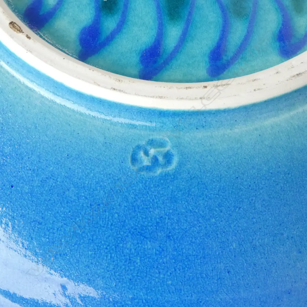 Merilyn Wiseman (1941-2019) round wide footed dish blue glazed with a central disc of repeating green and blue forms and flourishes to sides. Potter's mark lower side. Dia. 350mm Image 1++