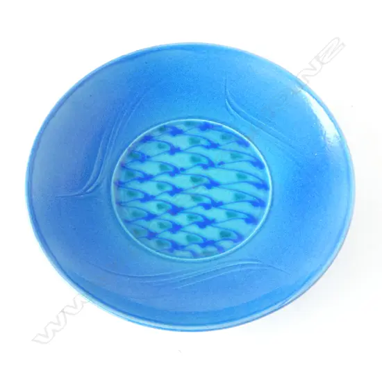 Merilyn Wiseman (1941-2019) round wide footed dish blue glazed with a central disc of repeating green and blue forms and flourishes to sides. Potter's mark lower side. Dia. 350mm