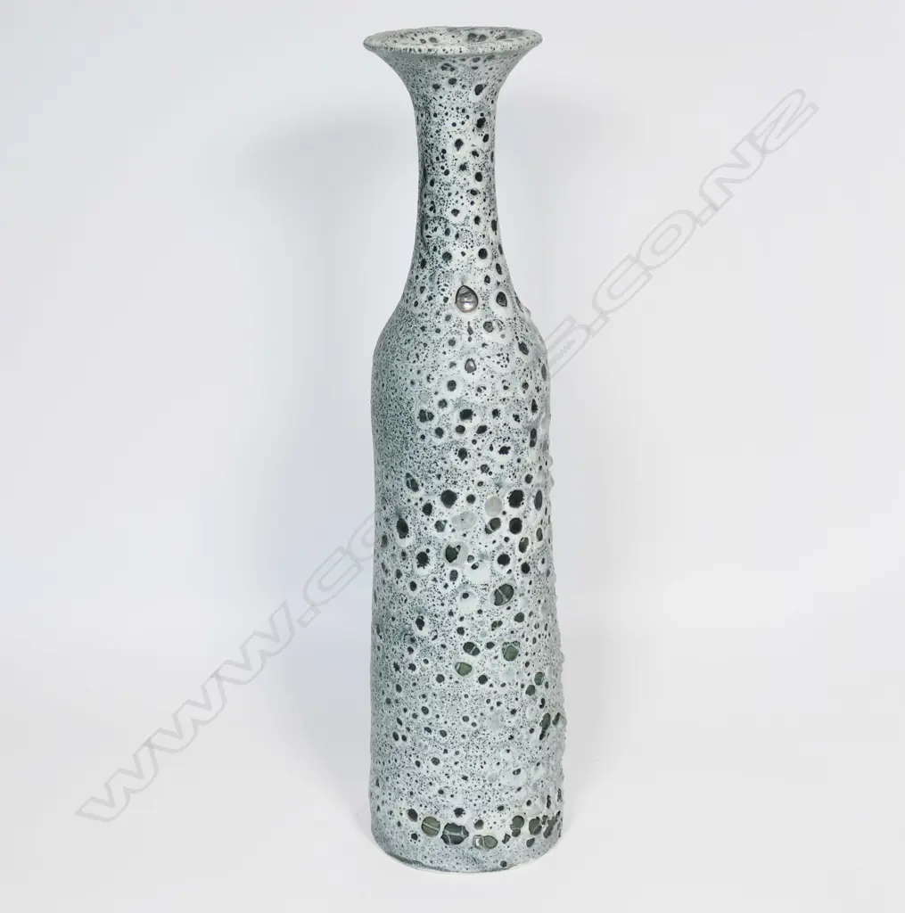 Graham Ambrose bubble glaze long bottle vase; the pale grey glaze on dark ground, long tapered cylindrical body. Impressed potters mark to base. H.485mm. Note: This unique high fired bubble glaze is one of four pieces made late 1990's early 2000's. Image 1++