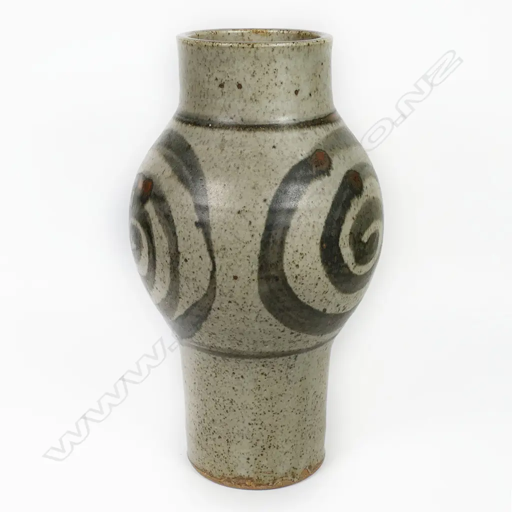 Adrian Cotter tall cylindrical vase with swollen mid-section decorated with large spiral motif. Impressed monogram near base. H.260mm. Provenance: purchased from an exhibition Alicat Gallery Ponsonby 1970s. Image 1++