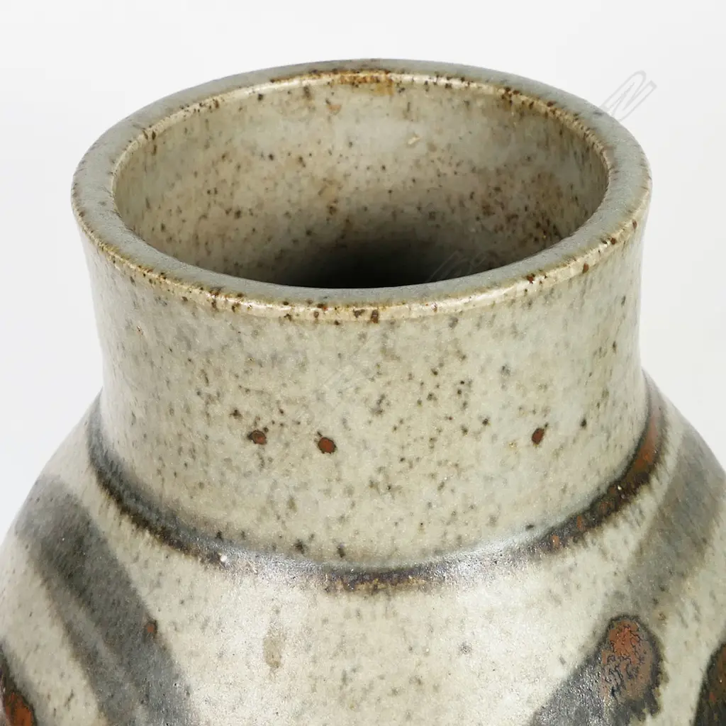 Adrian Cotter tall cylindrical vase with swollen mid-section decorated with large spiral motif. Impressed monogram near base. H.260mm. Provenance: purchased from an exhibition Alicat Gallery Ponsonby 1970s. Image 1++