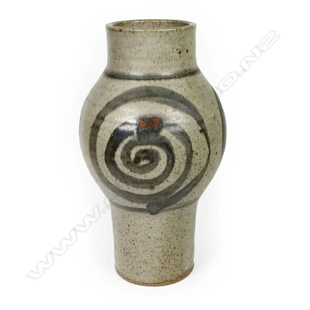 Adrian Cotter tall cylindrical vase with swollen mid-section decorated with large spiral motif. Impressed monogram near base. H.260mm. Provenance: purchased from an exhibition Alicat Gallery Ponsonby 1970s. Image 1++