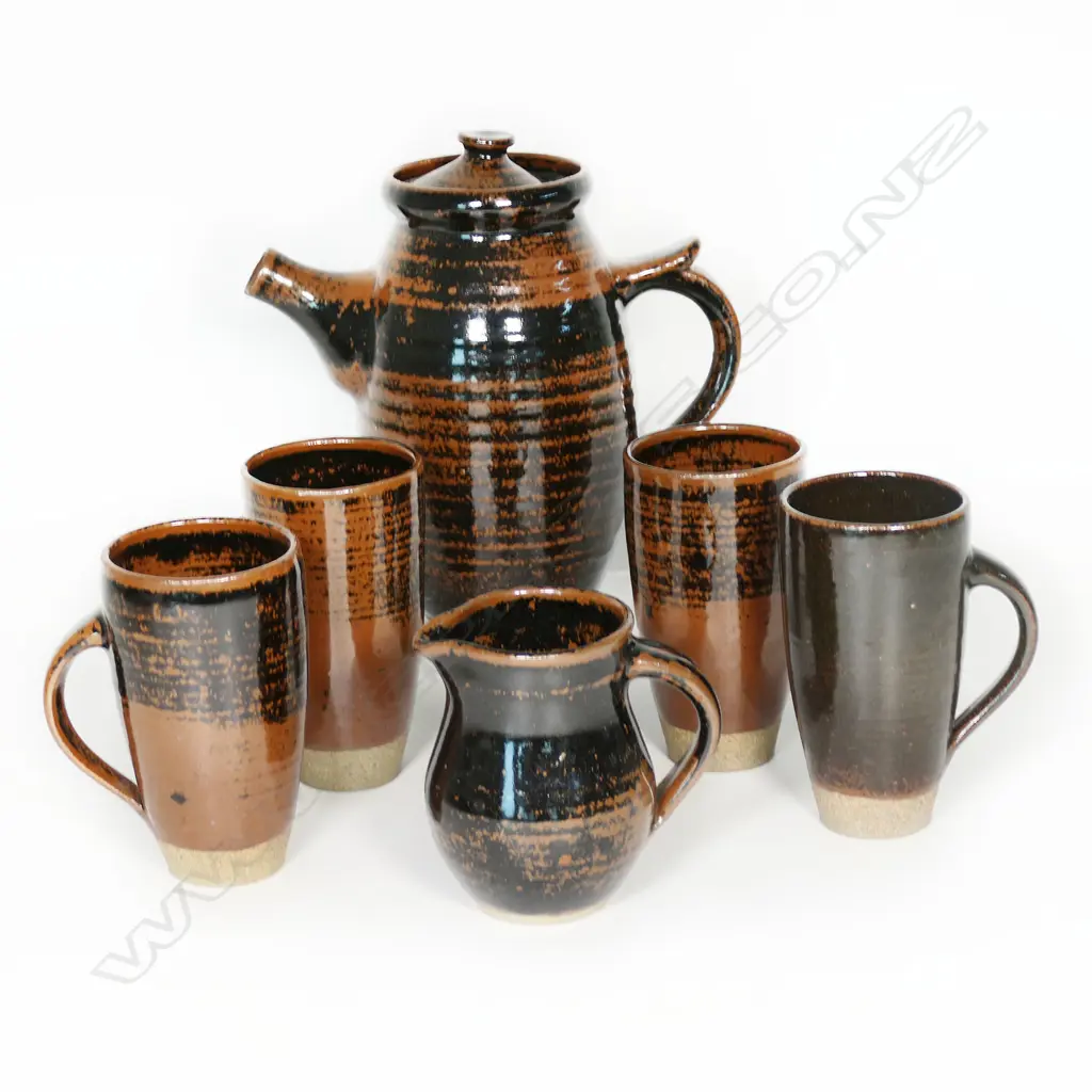 Frank Finan (Auckland) 1960's coffee set; tenmoku glaze brown and black: Coffee pot with four mugs and a jug. Image 1++