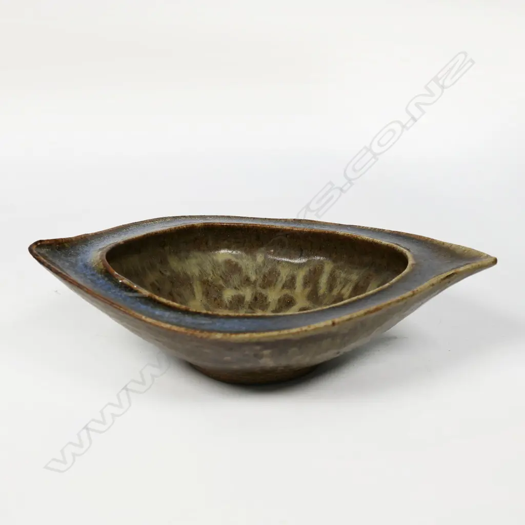 James Greig (1936–1986) 'Unfolding Form' bowl - an elliptical form stoneware bowl with green and brown glazes and mottled interior well. Initials incised to base. H.50 x 200 Image 1++