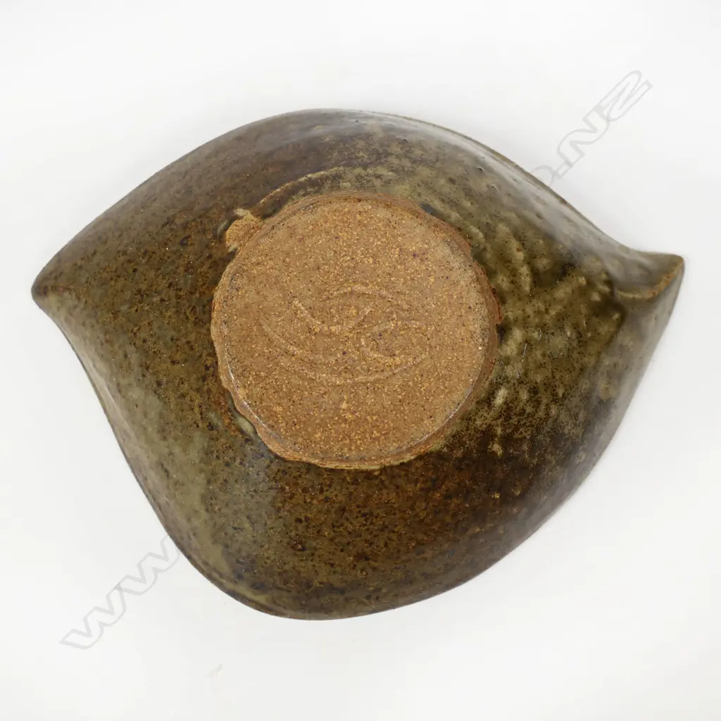James Greig (1936–1986) 'Unfolding Form' bowl - an elliptical form stoneware bowl with green and brown glazes and mottled interior well. Initials incised to base. H.50 x 200 Image 1++