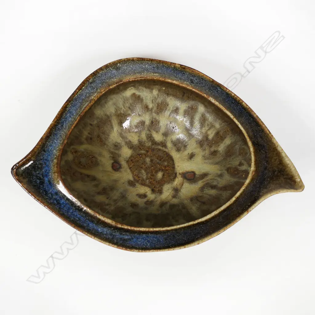 James Greig (1936–1986) 'Unfolding Form' bowl - an elliptical form stoneware bowl with green and brown glazes and mottled interior well. Initials incised to base. H.50 x 200 Image 1++