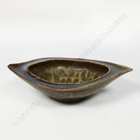 James Greig (1936–1986) 'Unfolding Form' bowl - an elliptical form stoneware bowl with green and brown glazes and mottled interior well. Initials incised to base. H.50 x 200