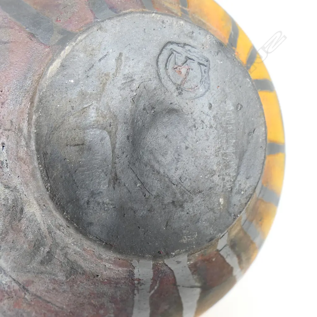 Mark James spherical vase; raku fired with altered mouth and lug handles. Decorated with overglazed flowers. Earth tones with copper glaze highlights. Potter's stamp to base. H.165mm Image 1++