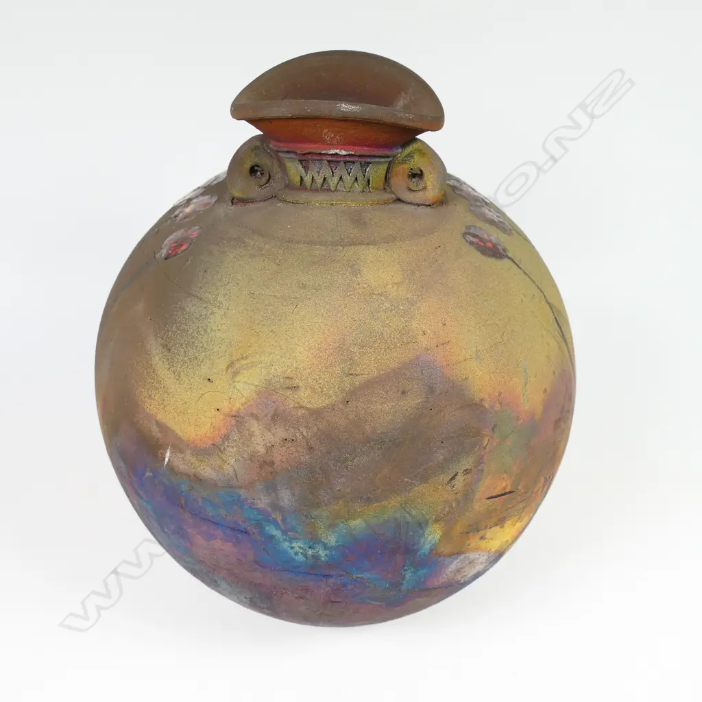 Mark James spherical vase; raku fired with altered mouth and lug handles. Decorated with overglazed flowers. Earth tones with copper glaze highlights. Potter's stamp to base. H.165mm Image 1++