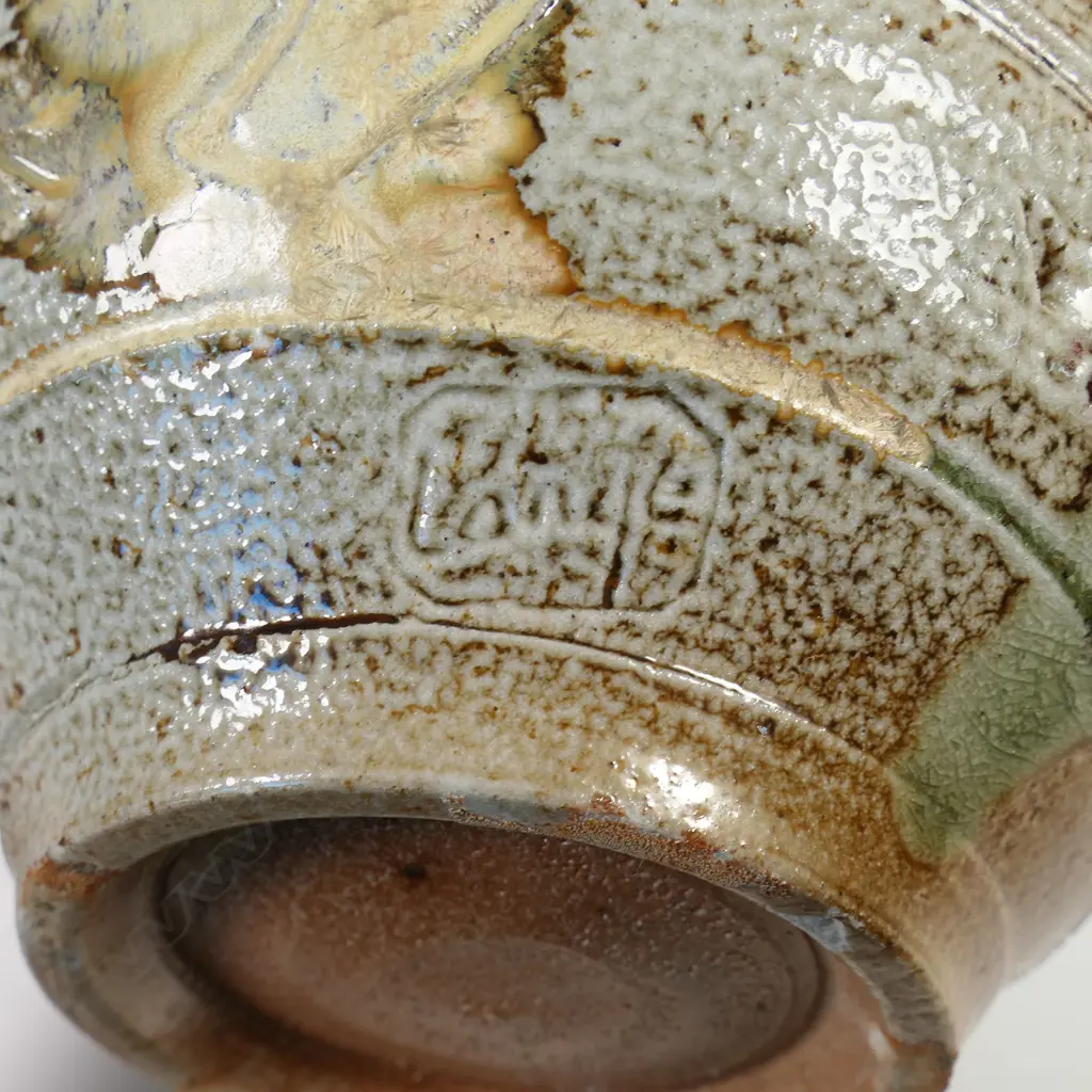 Peter Lange salt glazed footed bowl; olive brown glazed interior, exterior decorated with incised creatures and patterns. Potter's name stamped to side. Dia.204mm. H.110mm. Small chip underneath foot. Image 1++