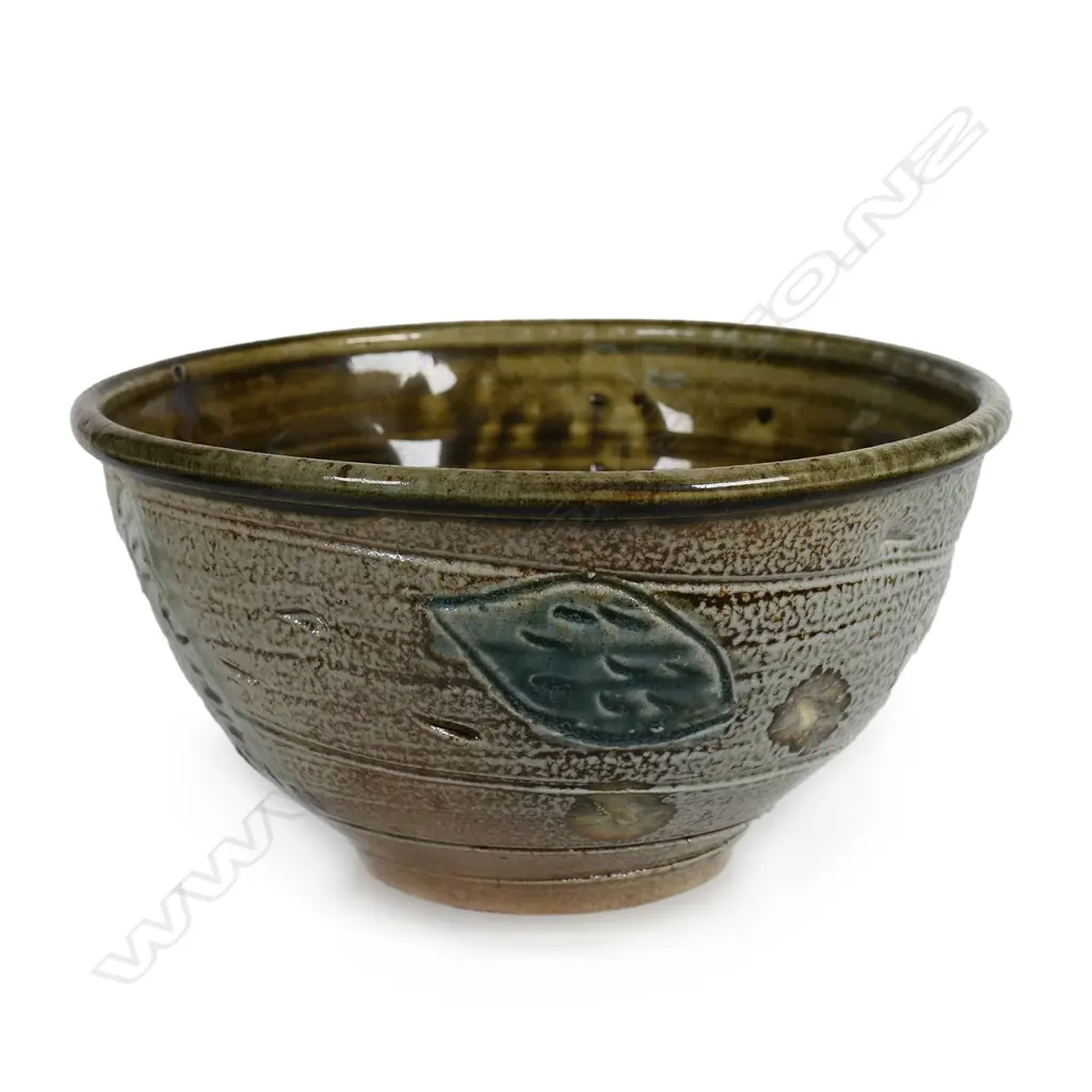 Peter Lange salt glazed footed bowl; olive brown glazed interior, exterior decorated with incised creatures and patterns. Potter's name stamped to side. Dia.204mm. H.110mm. Small chip underneath foot. Image 1++