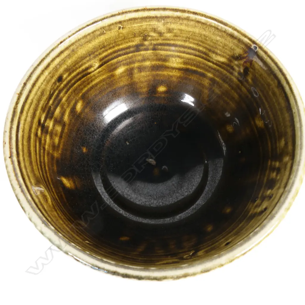 Peter Lange salt glazed footed bowl; olive brown glazed interior, exterior decorated with incised creatures and patterns. Potter's name stamped to side. Dia.204mm. H.110mm. Small chip underneath foot. Image 1++