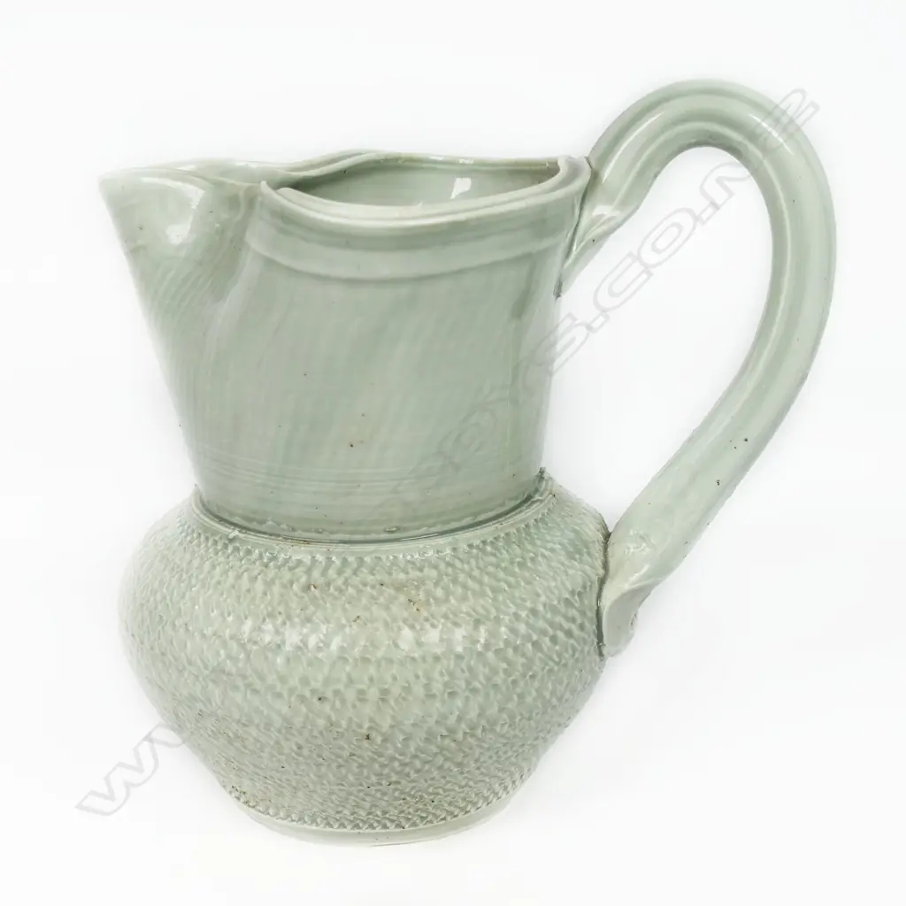 Ross Mitchell-Anyon (1954-2022) celadon glazed porcelain jug with textured body. Potter's mark at handle base. H.165mm. Image 1++