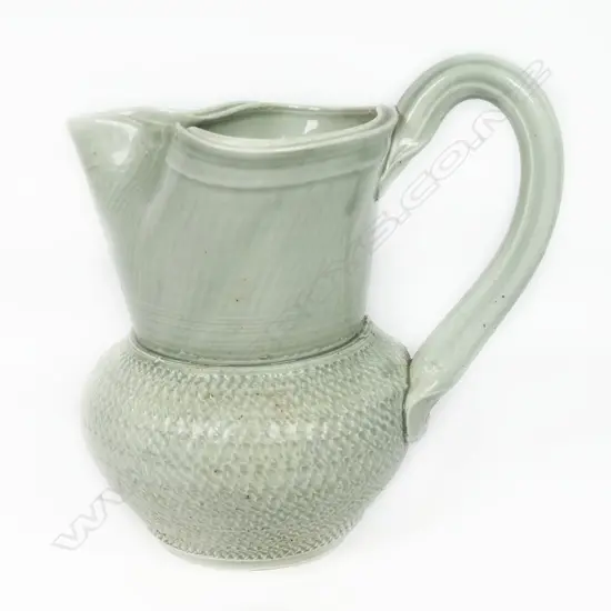 Ross Mitchell-Anyon (1954-2022) celadon glazed porcelain jug with textured body. Potter's mark at handle base. H.165mm.