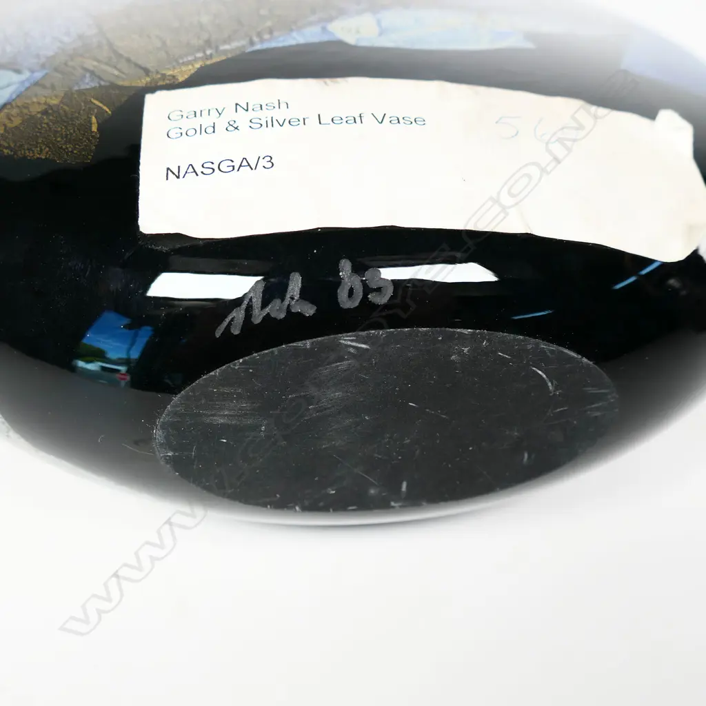 Garry Nash (ONZM) gold and silver leaf glass vase, of flattened ovoid form decorated with overlapping leaf patterns on a black ground. Signed and dated '03 to lower side. H.230mm Image 1++