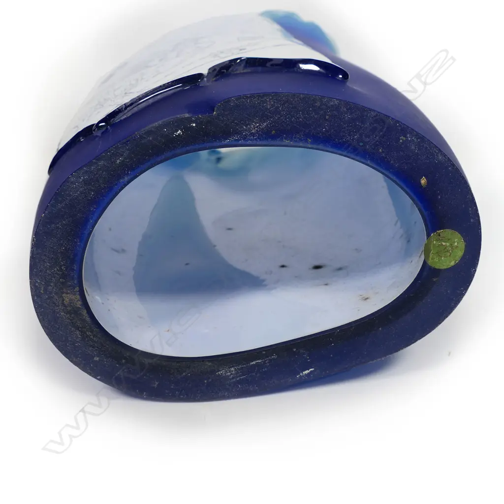 Garry Nash ONZM (1955-) exhibition art glass 'Introspection Poster Piece' from the important 'Bill Poster' series 1986. The graduating blue glass mildly tapered oval hollow section with applied white glass 'Bill Poster' featuring a gentleman at his desk, an extensive landscape with tree and distant town and an abstract section. Signed and dated '86. H.550mm, Image 1++