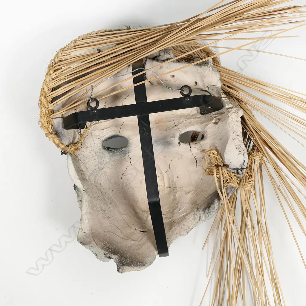 Helen Pollock raku fired mask with rope and reed adornment. Sturdy wall hanging assemblage to rear. Mask H.280 x 230mm, H.800mm total with reeds Image 1++