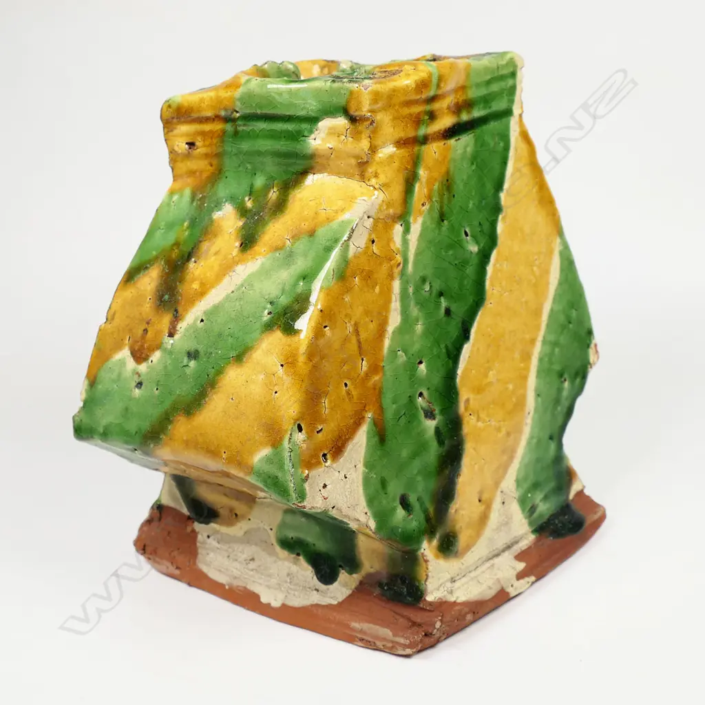 A large Richard Parker pottery vase; square baluster angular shape with quatrefoil mouth; with bands of caramel, green and pale glaze. Minor glaze frits. Artist's label to base. H.160mm. Image 1++