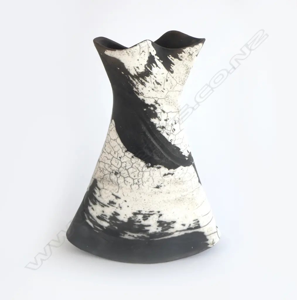 Rick Urban flared vase; flattened waisted form with curved base. Matte black and glossy white glaze effects. Impressed monogram to base. H.300mm Image 1++