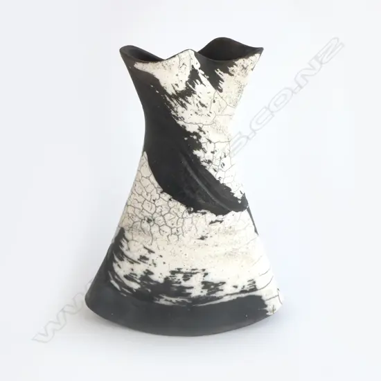 Rick Urban flared vase; flattened waisted form with curved base. Matte black and glossy white glaze effects. Impressed monogram to base. H.300mm