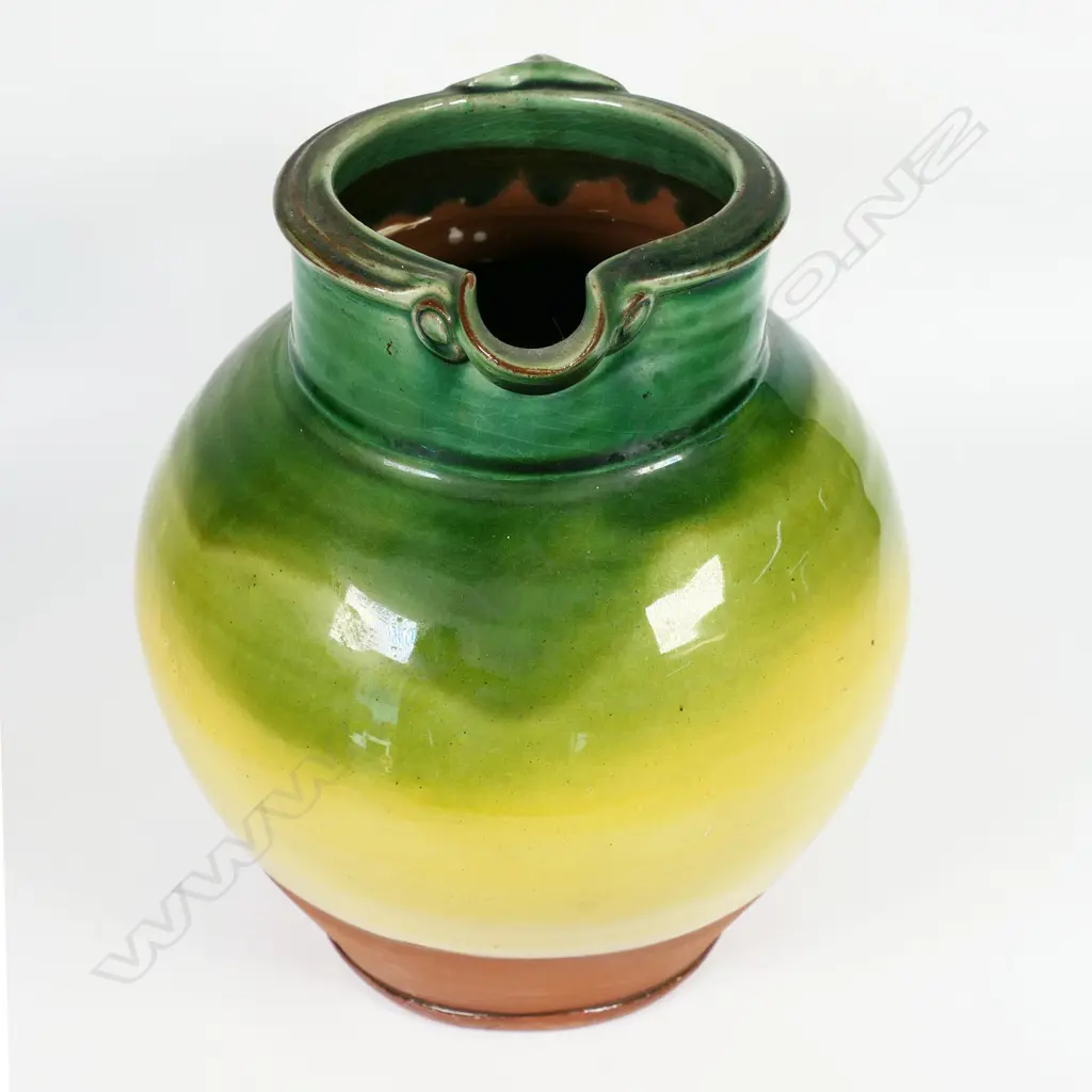 Andrew van der Putten large pitcher - with strap handle and a thick green glaze transitioning to yellow, potter's mark to base. H.200mm Image 1++