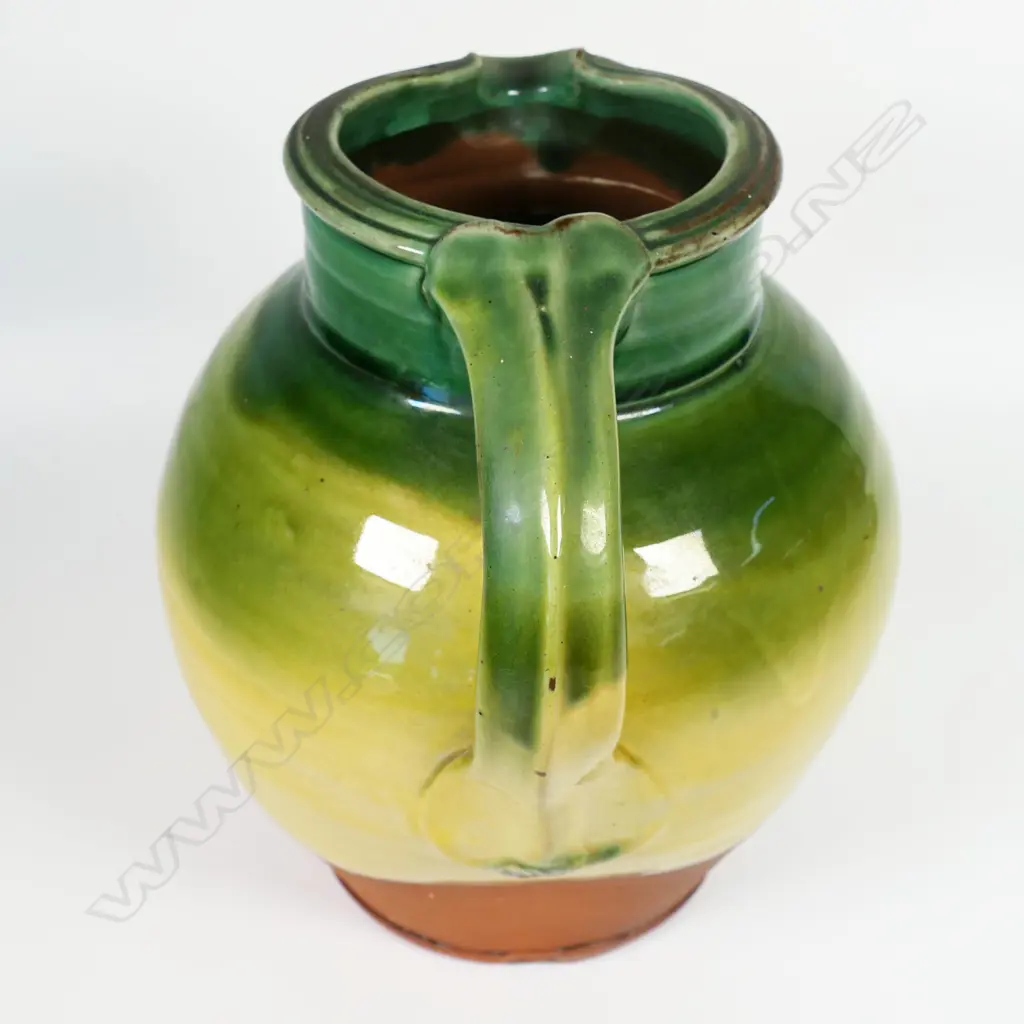 Andrew van der Putten large pitcher - with strap handle and a thick green glaze transitioning to yellow, potter's mark to base. H.200mm Image 1++