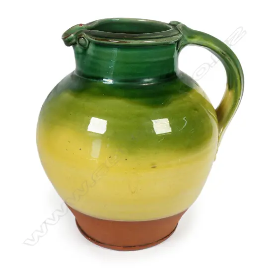 Andrew van der Putten large pitcher - with strap handle and a thick green glaze transitioning to yellow, potter's mark to base. H.200mm