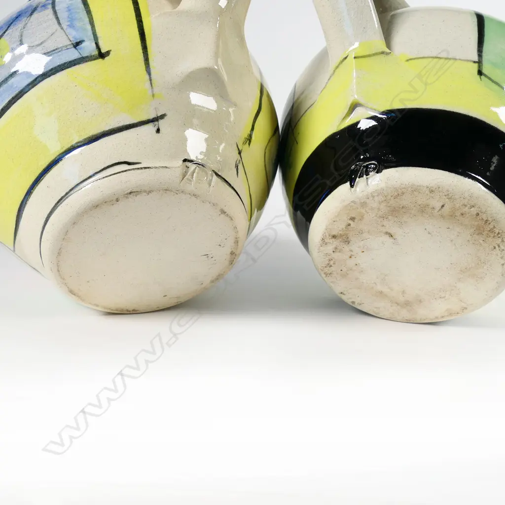 Two Andrew van der Putten jugs - bright modern designs with bird eye spout detail. Both with potter's mark to base. H.140/150mm Image 1++