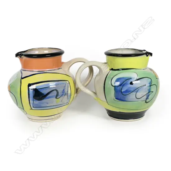 Two Andrew van der Putten jugs - bright modern designs with bird eye spout detail. Both with potter's mark to base. H.140/150mm