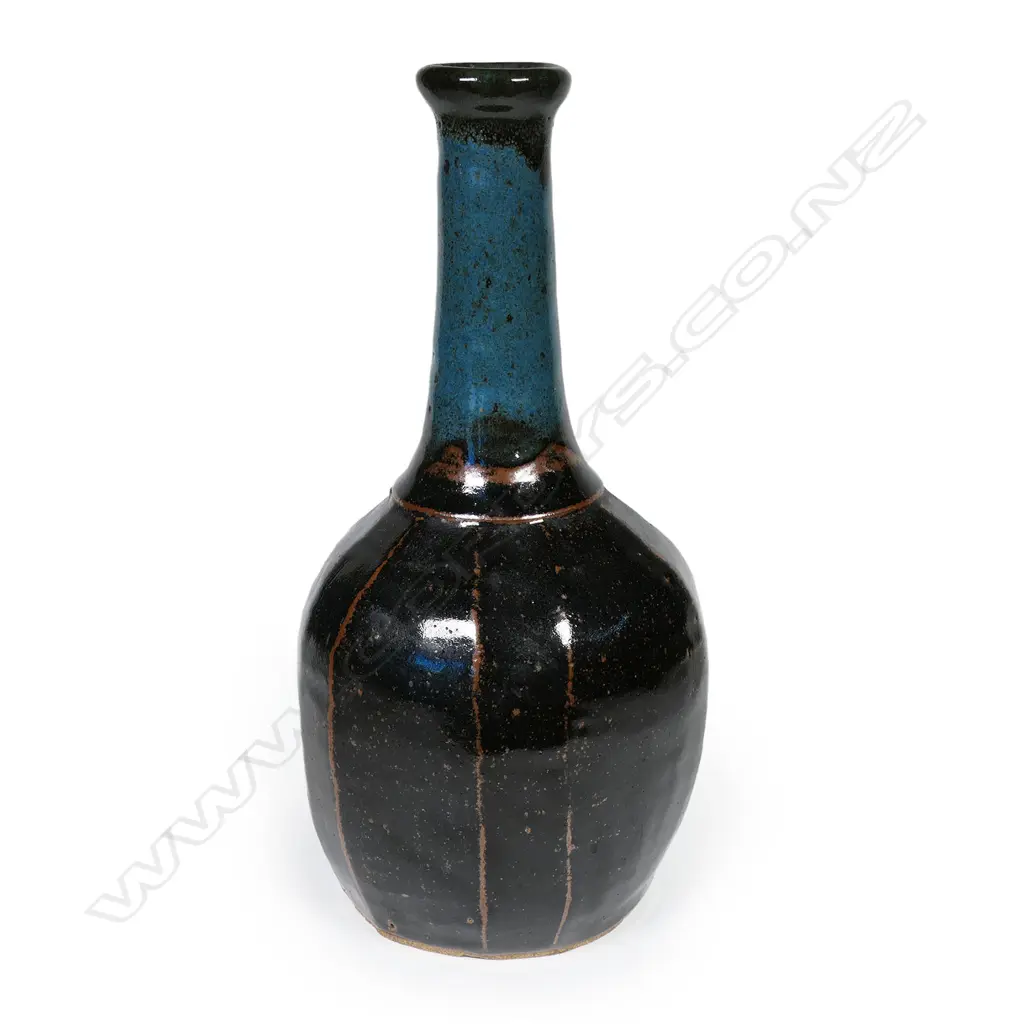 Potter unknown Anglo-Oriental mallet form stoneware vase. The facetted body with tenmoku glaze. Blue glaze to the neck. Apparently unmarked. H.350mm. Image 1++