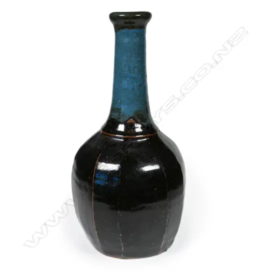 Potter unknown Anglo-Oriental mallet form stoneware vase. The facetted body with tenmoku glaze. Blue glaze to the neck. Apparently unmarked. H.350mm.