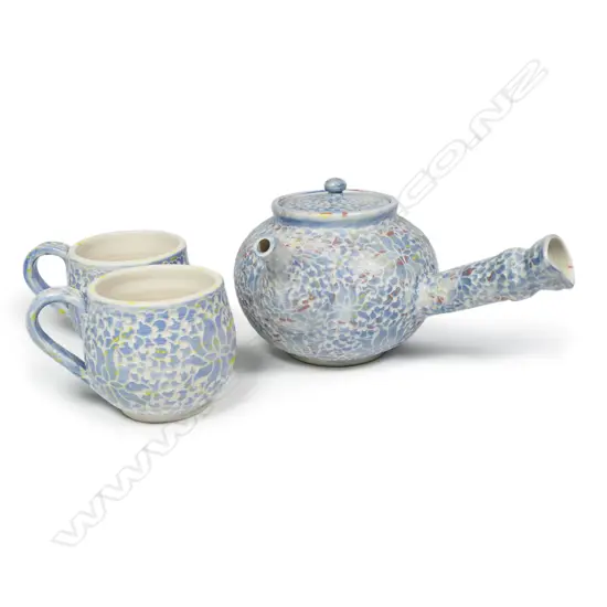 Keum Sun Lee/Sang Sool Shim teapot and two cups -pale blue with sgrafitto floral design and red and yellow high lights. Teapot Dia.160 X 120mm