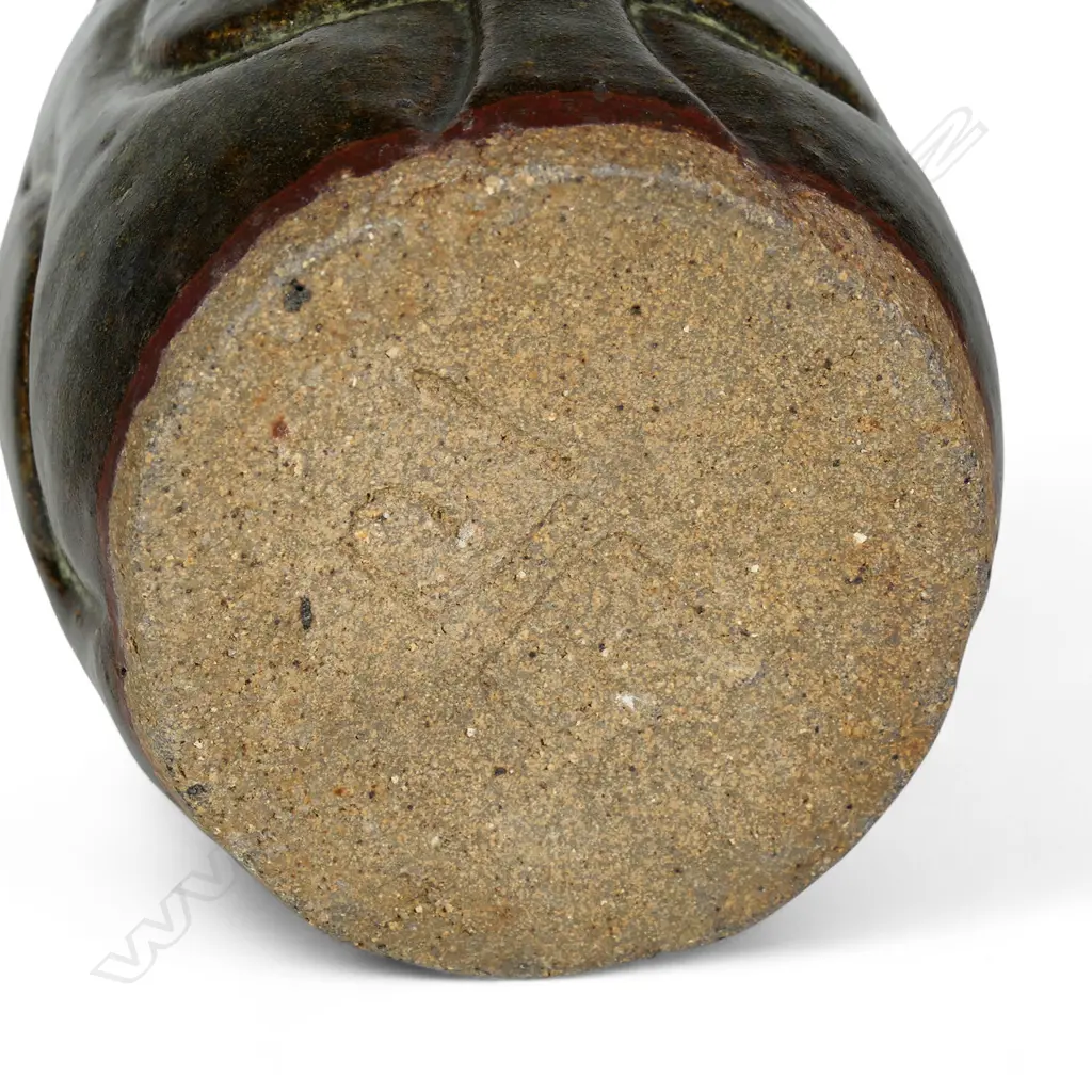 Jim Greig sculpted pottery vase, ovoid form with four relief sculpted double bladed (kotiate) forms, the dark brown/green glaze with pale and red/brown highlights, incised potter's mark to base. H.205mm. Image 1++