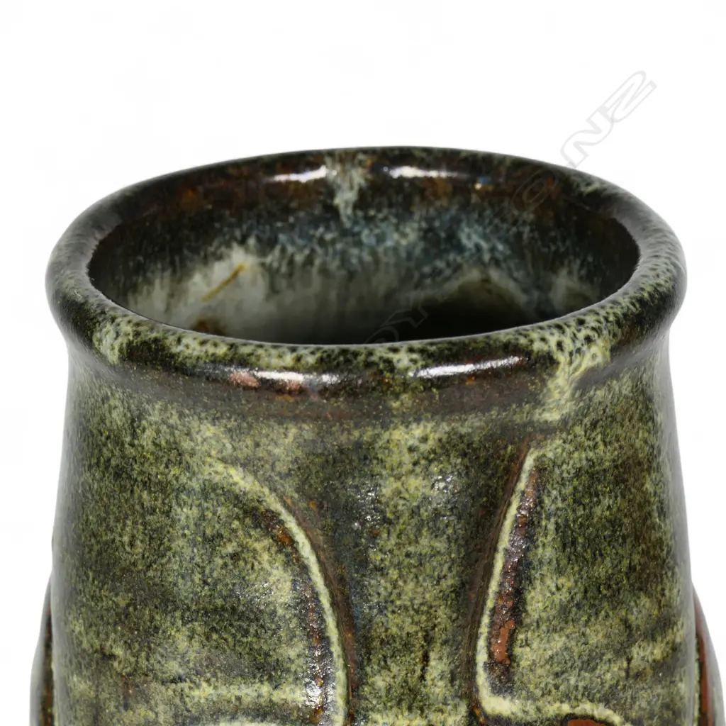 Jim Greig sculpted pottery vase, ovoid form with four relief sculpted double bladed (kotiate) forms, the dark brown/green glaze with pale and red/brown highlights, incised potter's mark to base. H.205mm. Image 1++