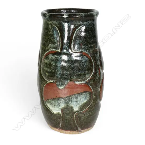 Jim Greig sculpted pottery vase, ovoid form with four relief sculpted double bladed (kotiate) forms, the dark brown/green glaze with pale and red/brown highlights, incised potter's mark to base. H.205mm.