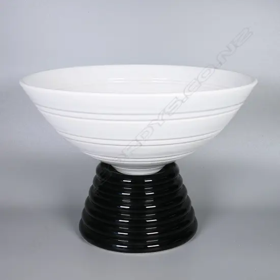 John Parker ribbed white porcelain bowl on a tiered black porcelain stand. Dia.270mm H.200mm with stand. Artist's name and VIII stamped to base