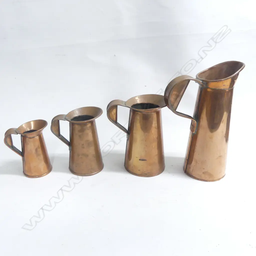 A set of four 19th C graduated copper jugs. Tallest 265mm Image 1++