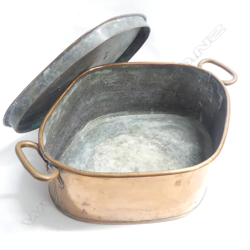 A Victorian copper Turbot pan of rhombus shape to accept the fish with two loop handles to the rim and lid with riveted handle. W.550mm across handles. Image 1++